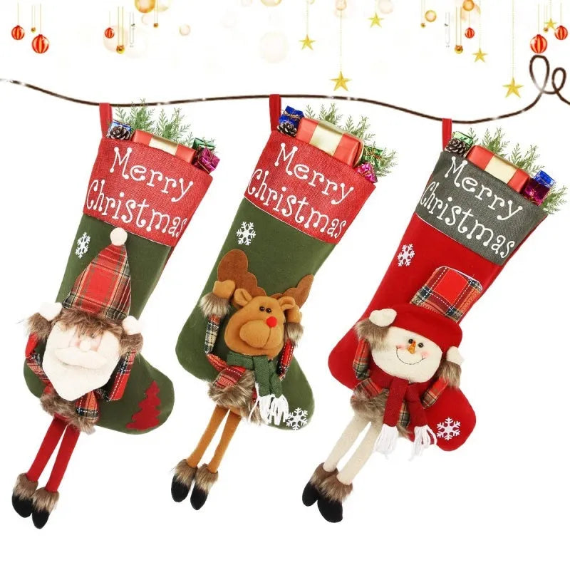 Three large Christmas stockings with Santa Snowman Reindeer 3D plush designs for holiday tree decoration