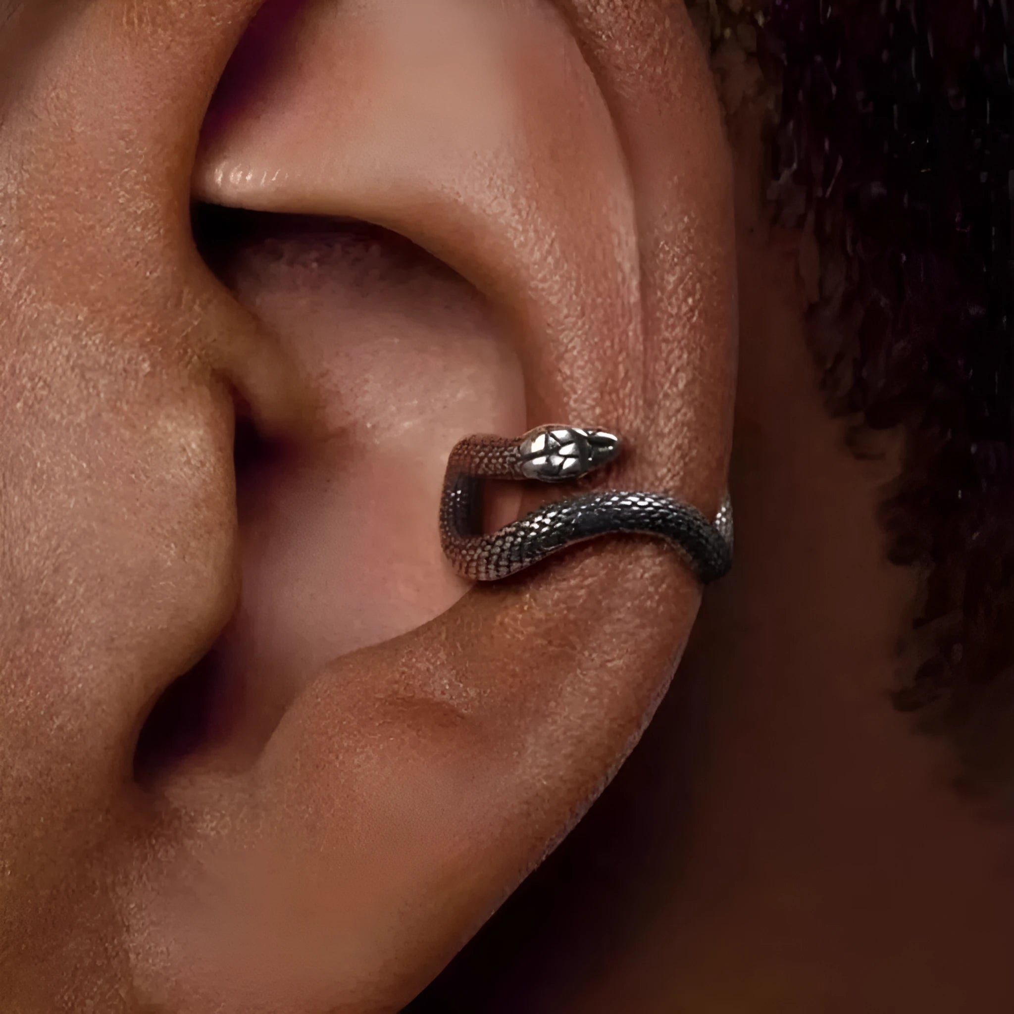 Retro snake-shaped alloy ear clip with electroplated finish on a neutral background