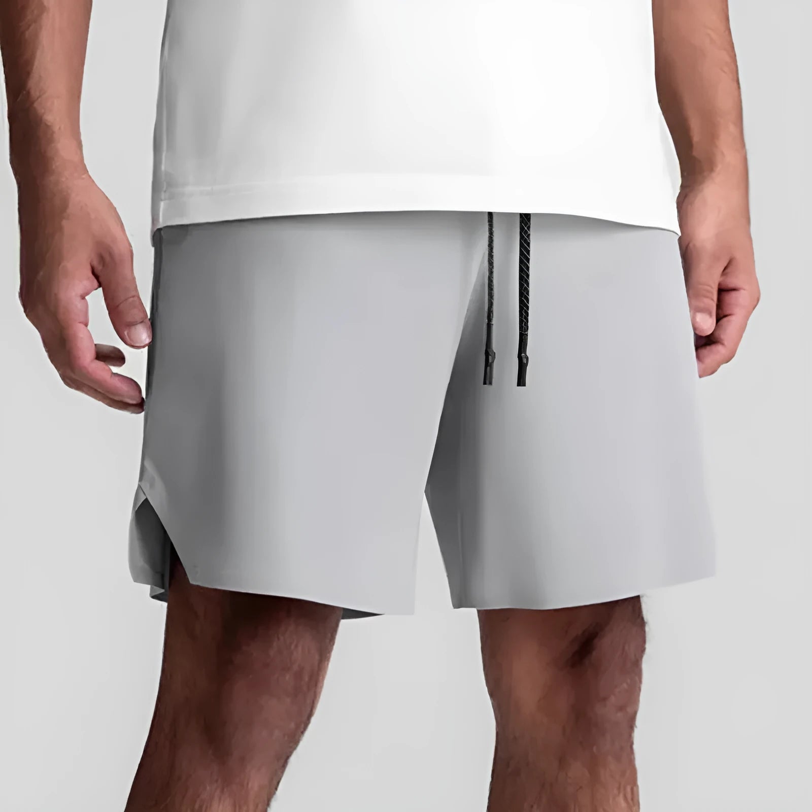Men's grey seamless sports shorts with a straight-leg, knee-length cut on a mannequin.