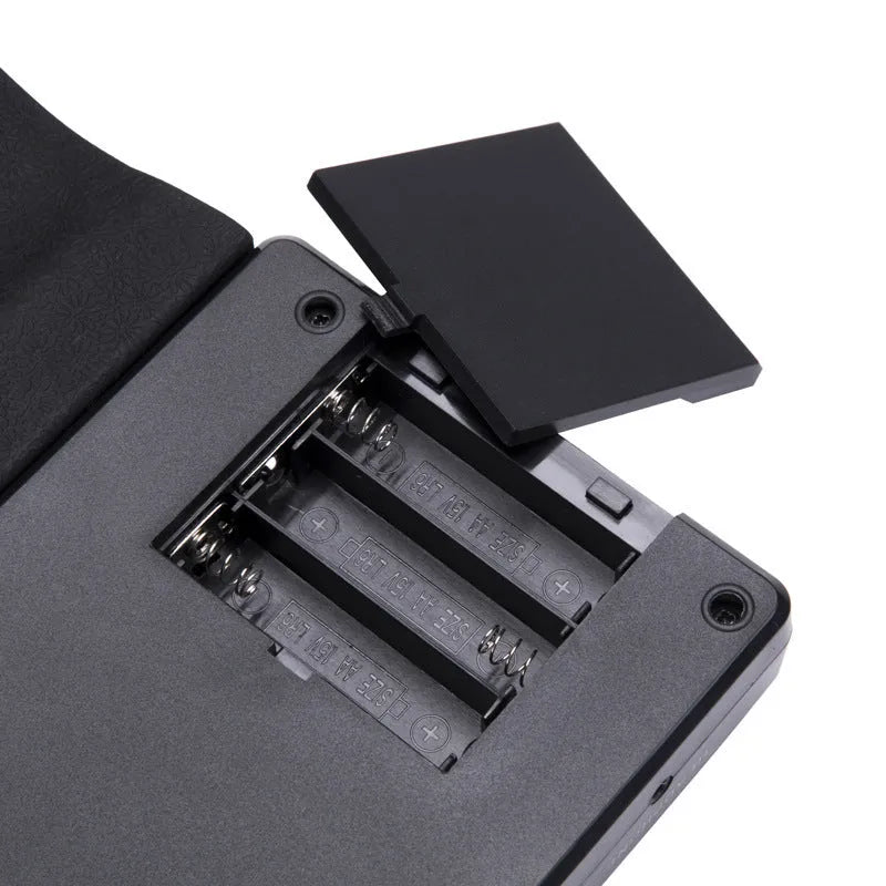 Pearl white portable folding electronic keyboard with 49 silicone keys and a built-in speaker, shown folded and unfolded.
