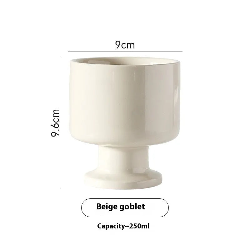 Hand-pinched irregular ceramic mug in a solid colour, showing its unique shape.