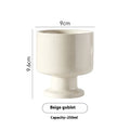 Hand-pinched irregular ceramic mug in a solid colour, showing its unique shape.