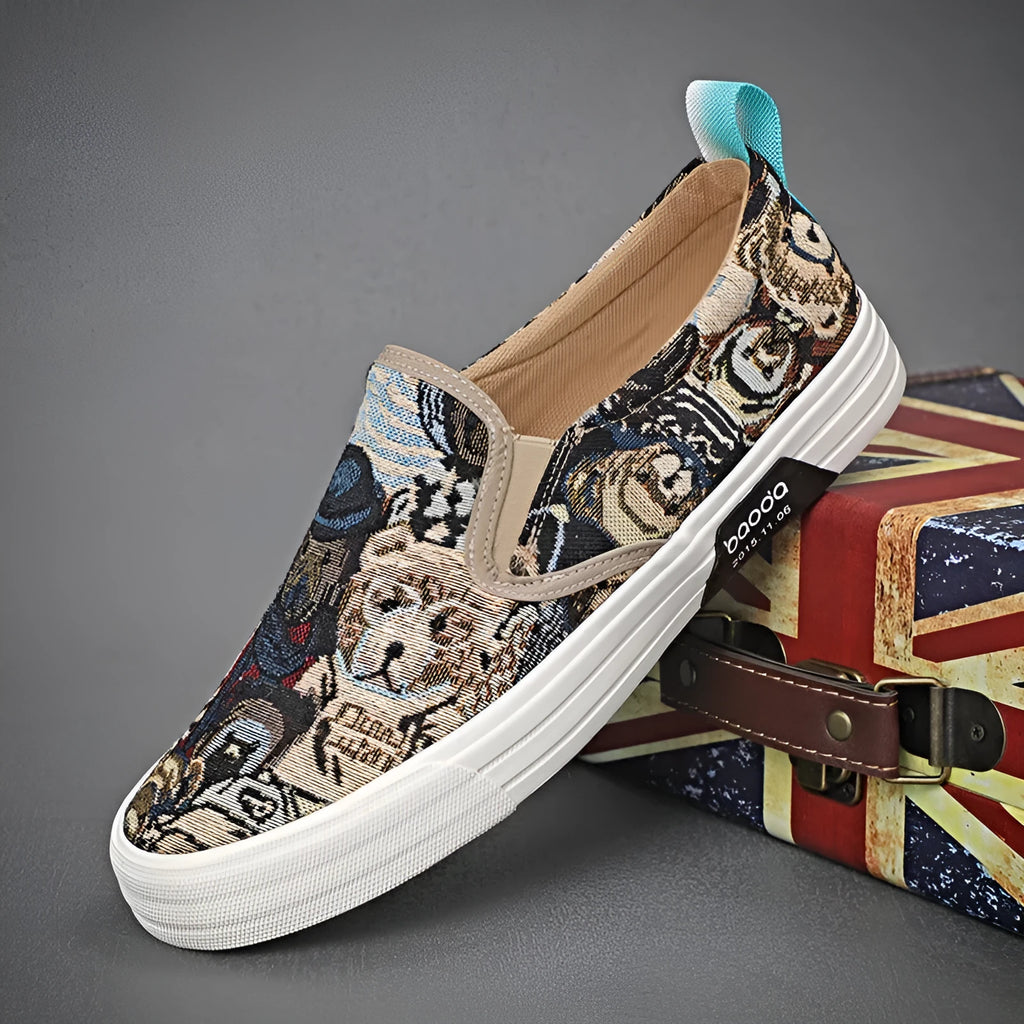 A pair of low-top canvas slip-on sneakers with a round toe and vulcanised rubber sole on a neutral background.