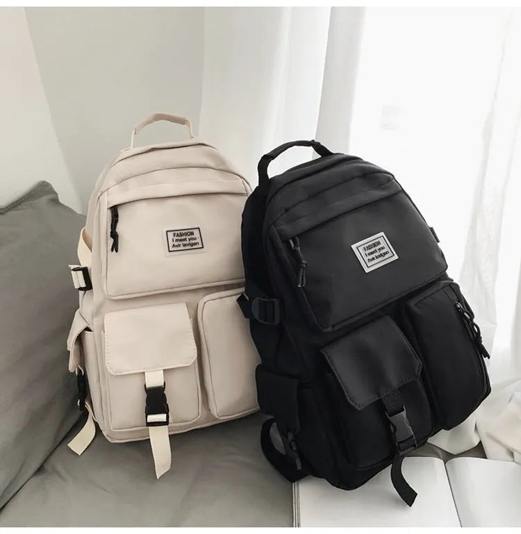 Black and white nylon student backpack with laptop compartment and 3D pockets.