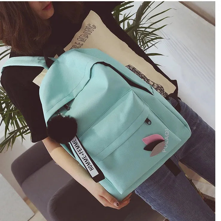 Canvas college schoolbag with leaves pattern showing anti-theft features and adjustable shoulder straps