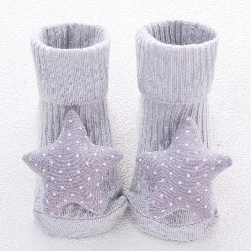Cotton baby socks with non-slip soles in multiple designs including bows, stars, and animal prints.