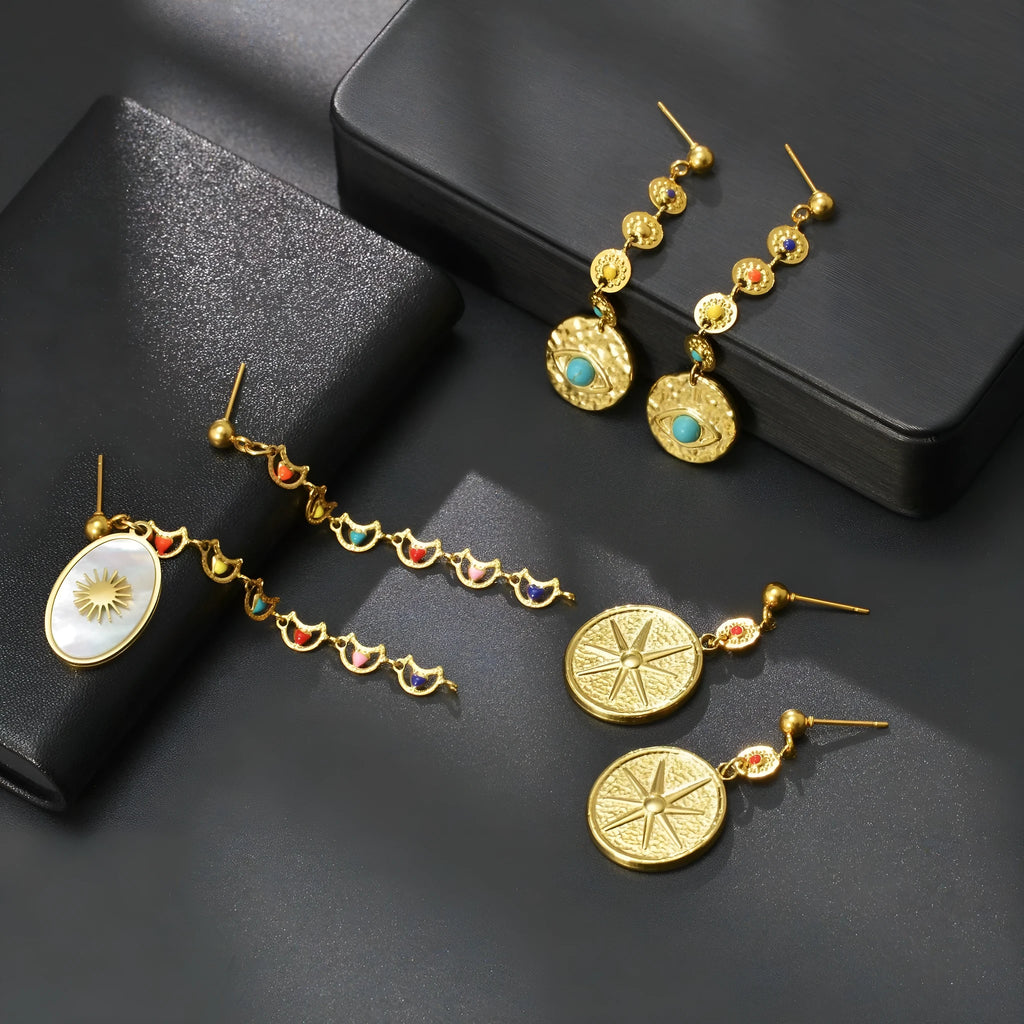 Geometric stainless steel earrings showing Eight Awn Star, Eye, and Shell Sun design options