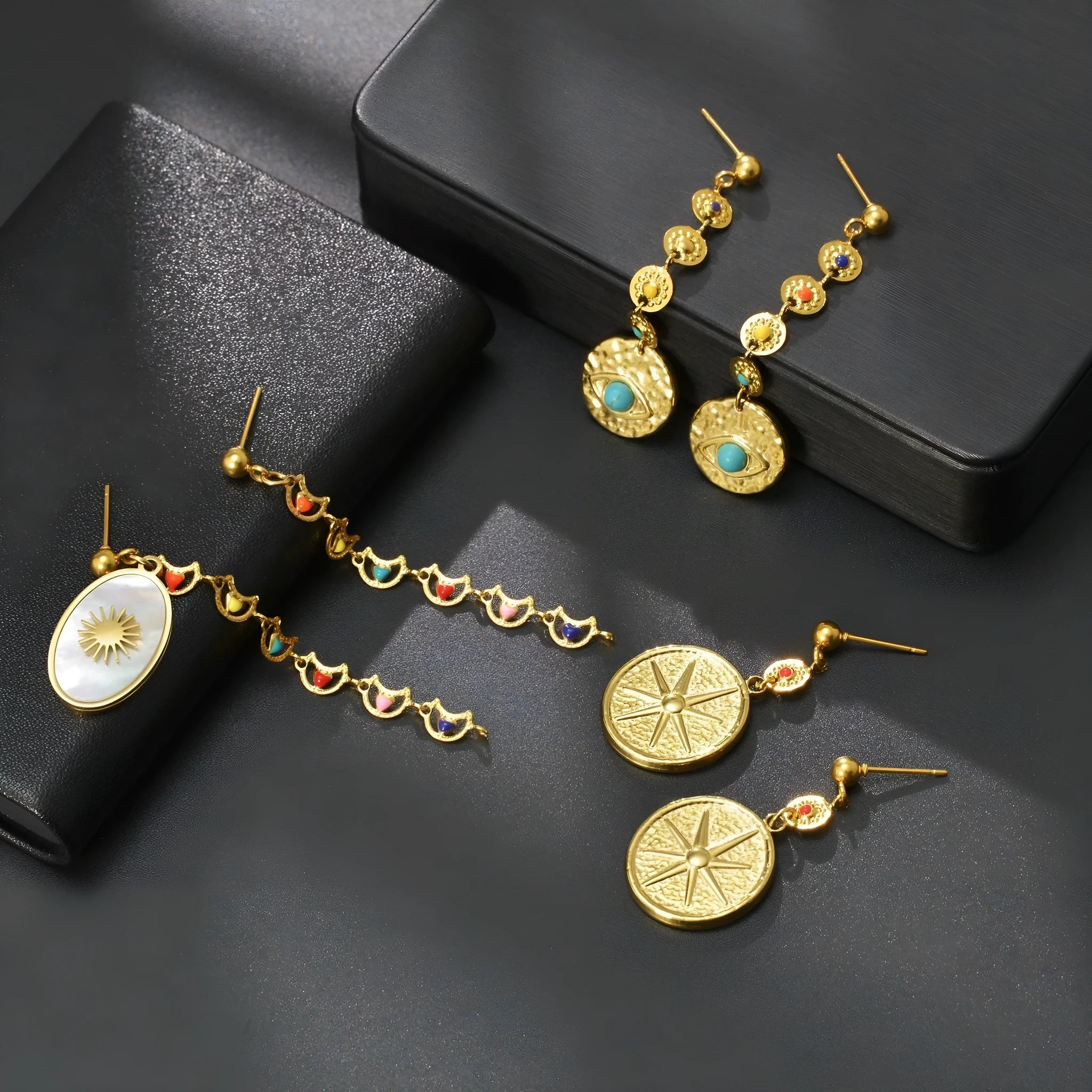 Geometric stainless steel earrings showing Eight Awn Star, Eye, and Shell Sun design options