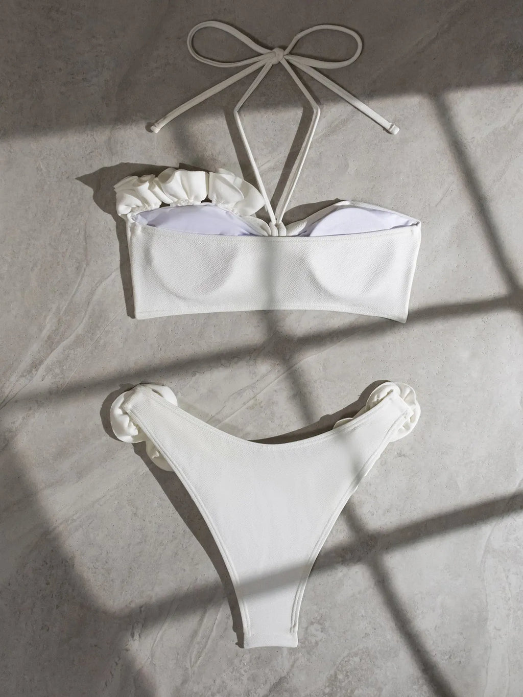 White halter neck lace-up bikini with split-cup design and three-dimensional floral details