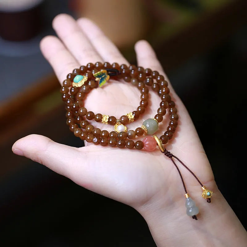 Brown jade Hetian jade women's bracelet with silver accents in a geometric three-ring design.