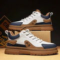 Black and white platform casual sneakers with thick rubber soles and colour-panelled pattern detailing
