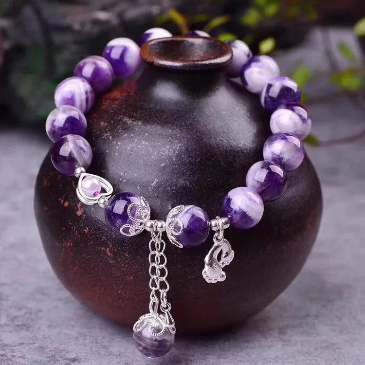 Amethyst bracelet for women with 10mm round beads on a wrist.