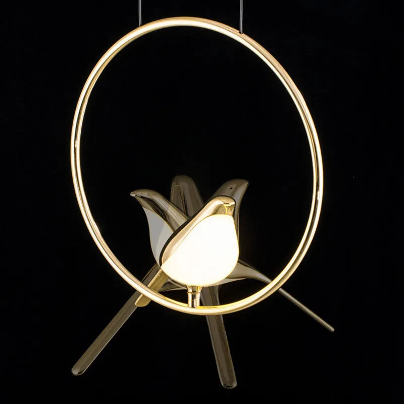 Minimalist clear acrylic magpie bird chandelier ceiling light with a metallic frame.