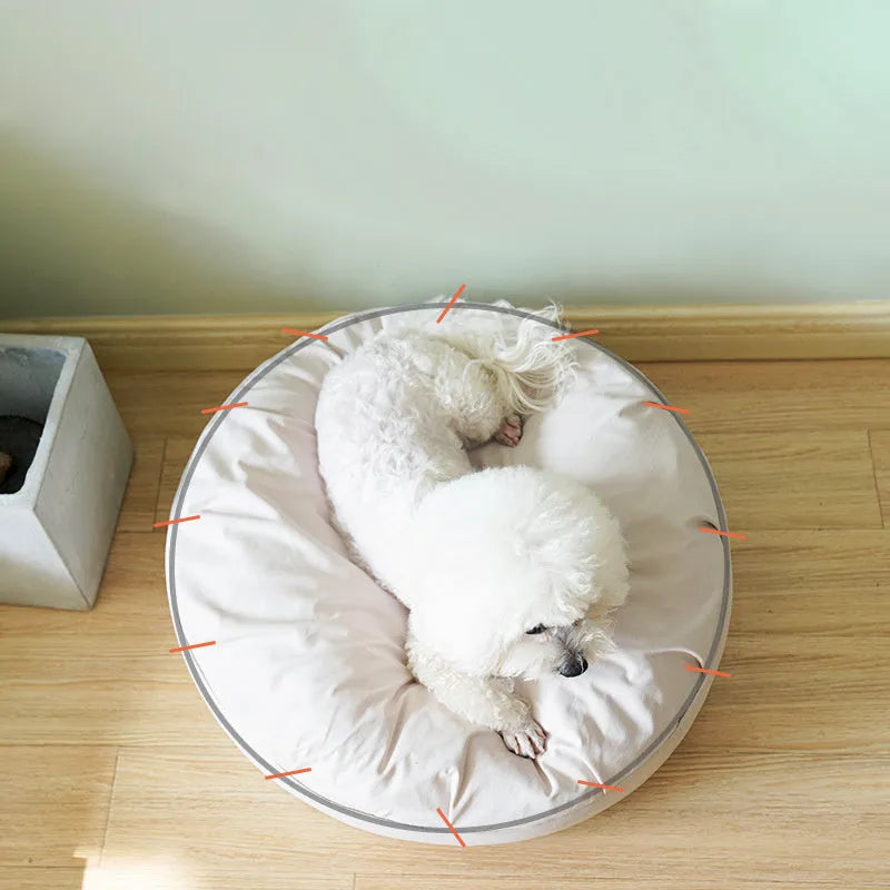 Fluffy pet bed in beige with raised rim on a light wood floor, available in sizes 60 to 80 cm diameter
