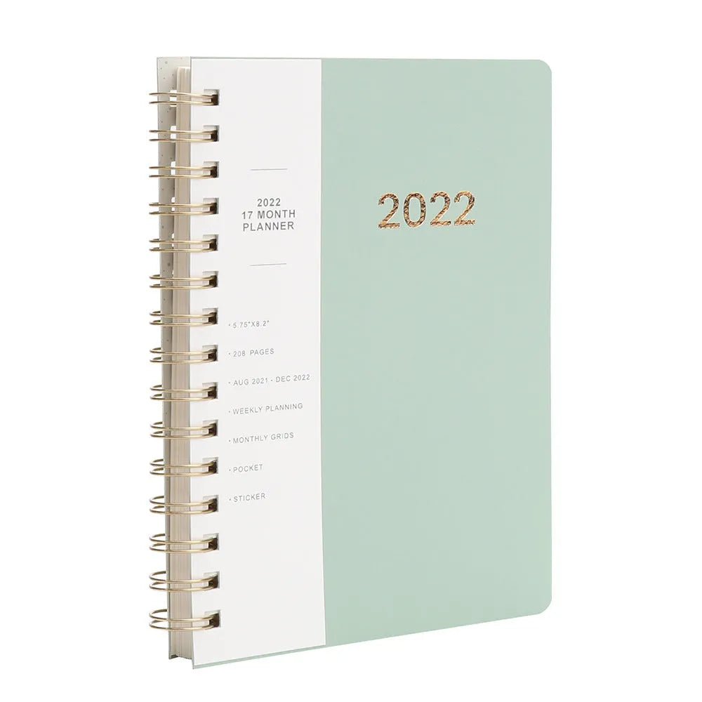 Blue A6 student weekly planner notebook with coil binding, open to show pages and pockets.