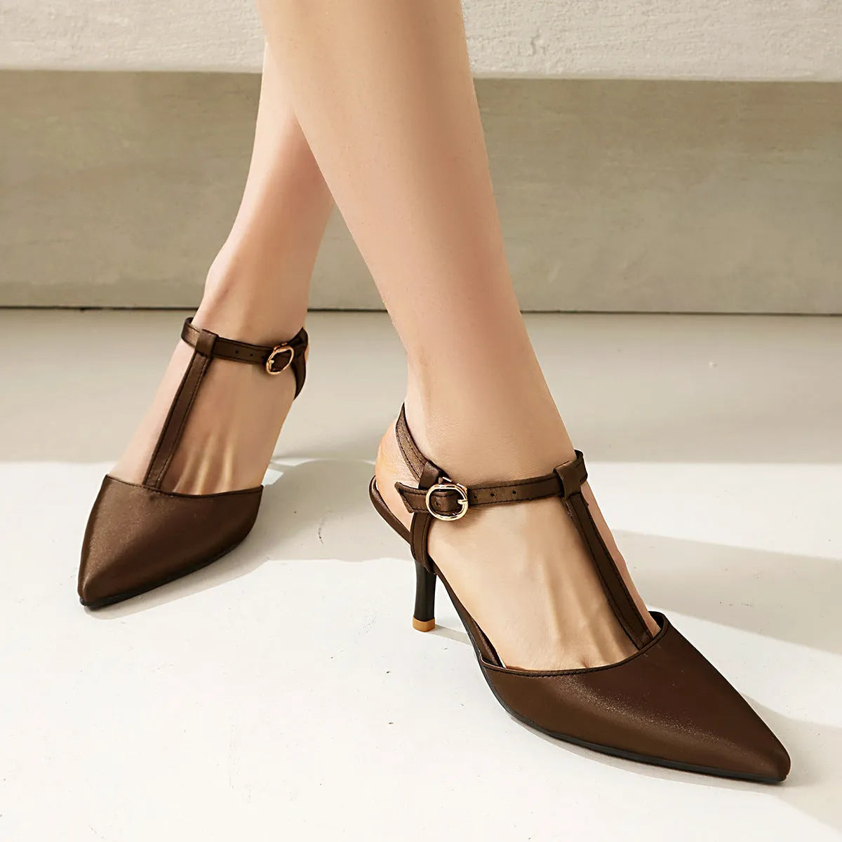 Pointed T-strap high heels in top grain leather, available in black and brown