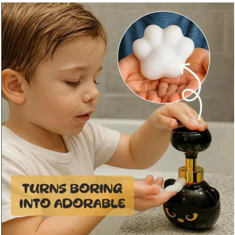 Black plastic cartoon cat shaped foam soap dispenser on a bathroom countertop.
