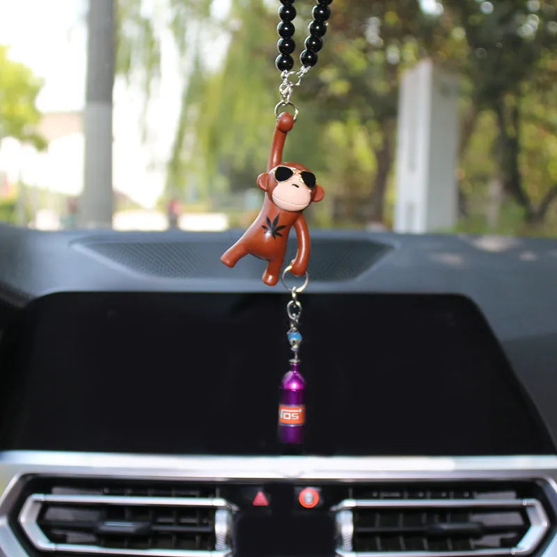 Cartoon monkey wearing sunglasses rearview mirror pendant on a bead necklace.
