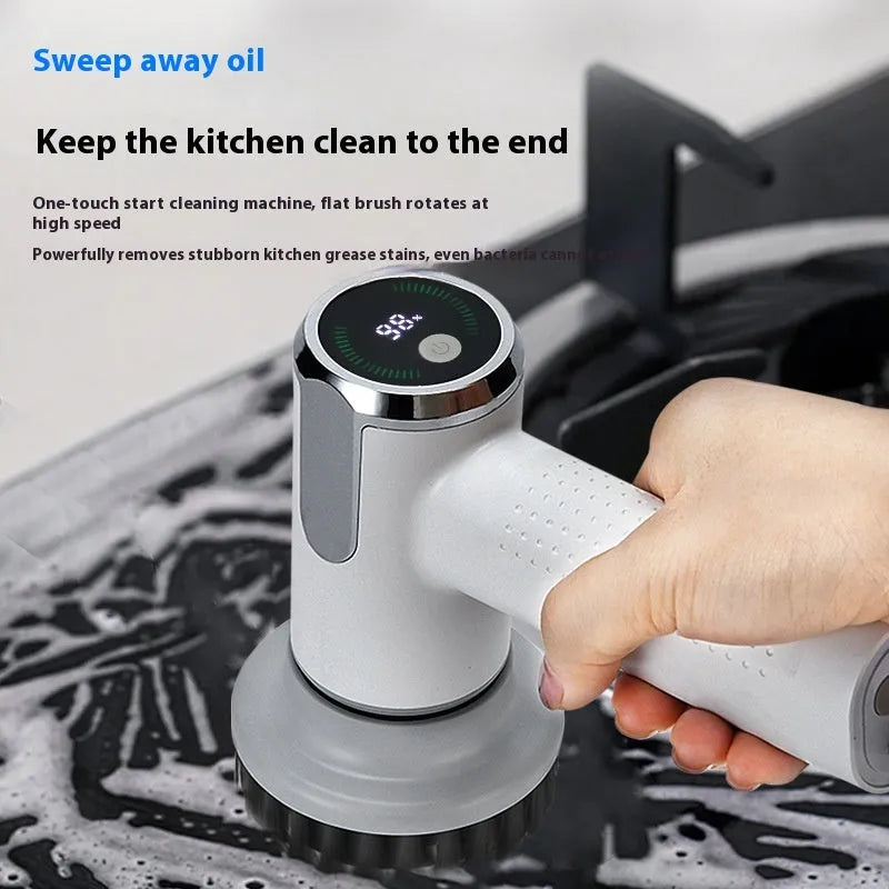 White cordless electric cleaning brush with interchangeable scrubber heads on a kitchen counter