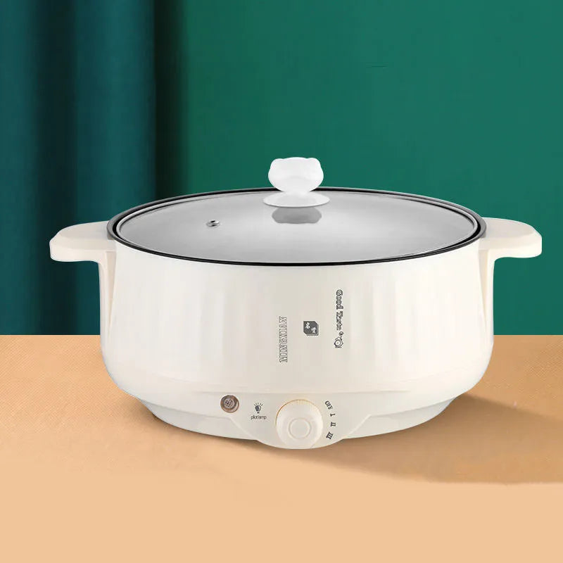 White electric hot pot with non-stick coating and stainless steel construction showing cooking functions