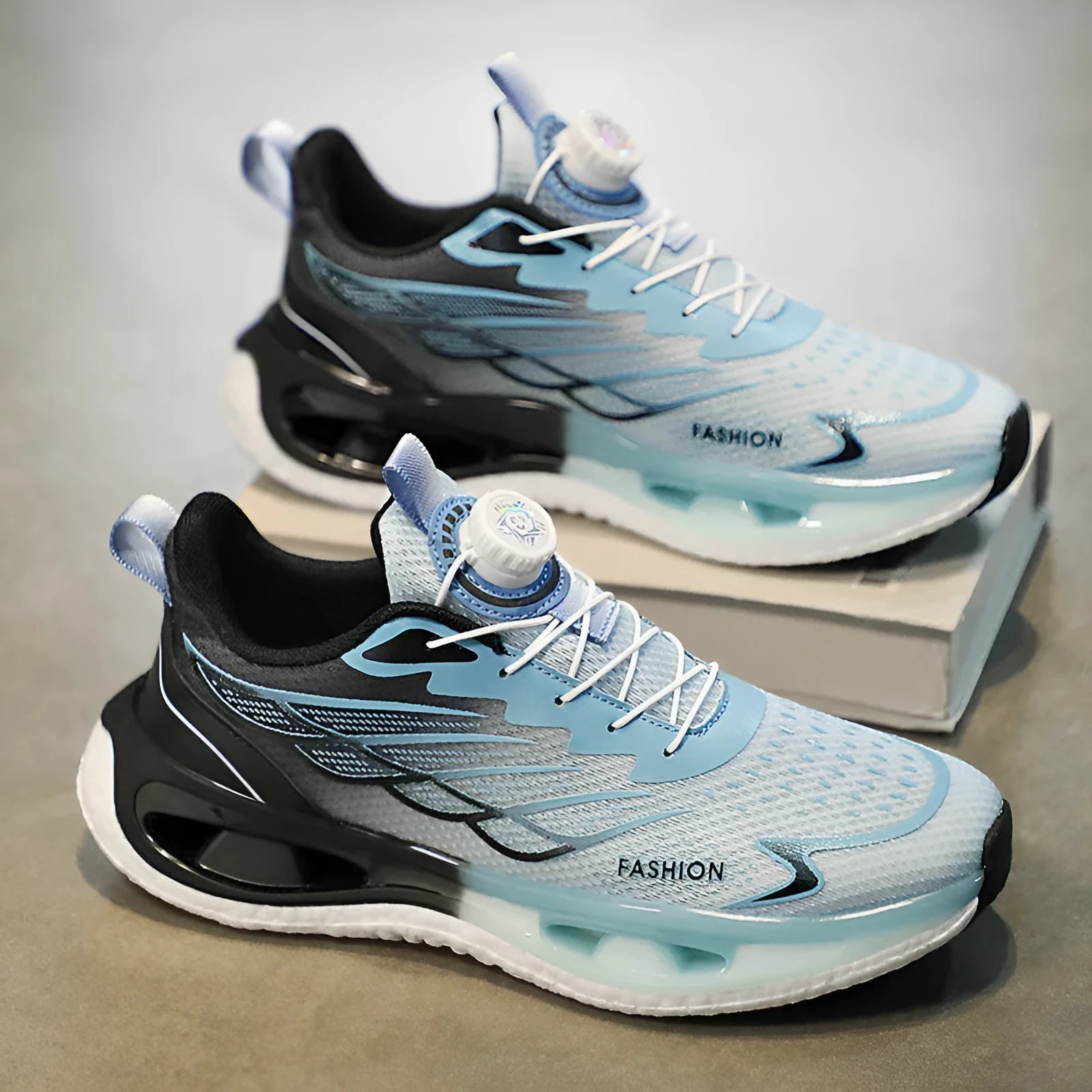 Low top youth sneaker with rotating button fastener in light blue, black, or white and blue colourways.