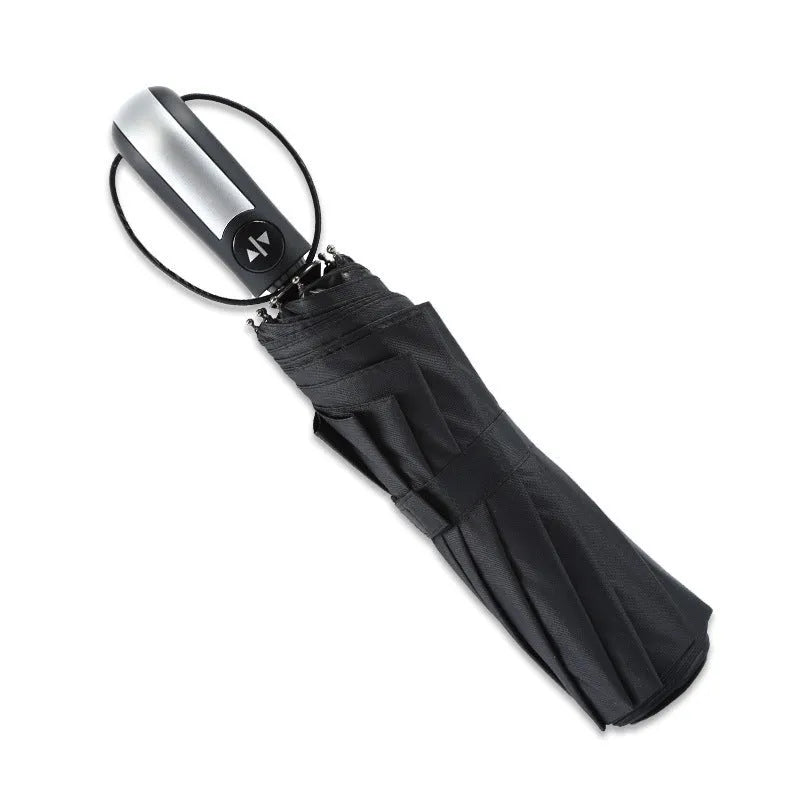 Black triple folding automatic umbrella with a palace-style shape and rubber handle.