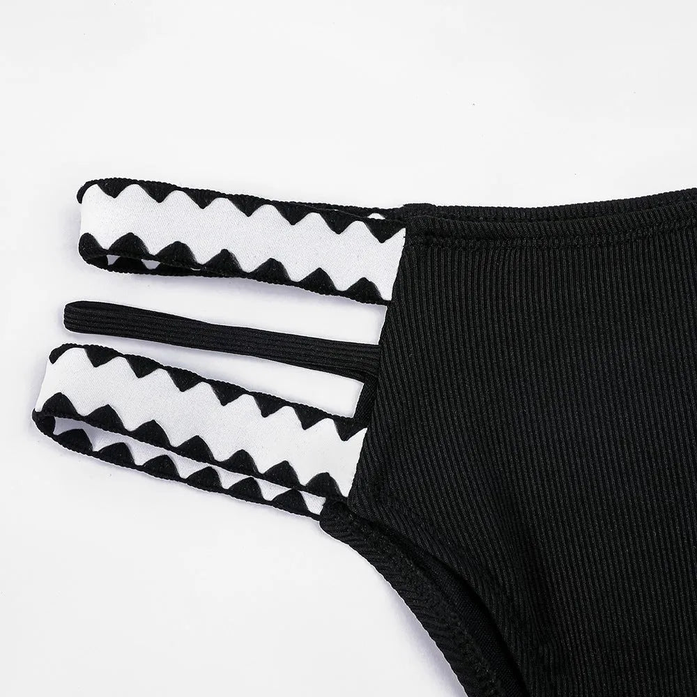 Black women's bikini swimsuit with a hollowed-out split design and brief style.