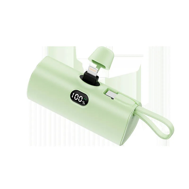 Compact capsule‑shaped digital display power bank with integrated plug, shown in multiple colours.