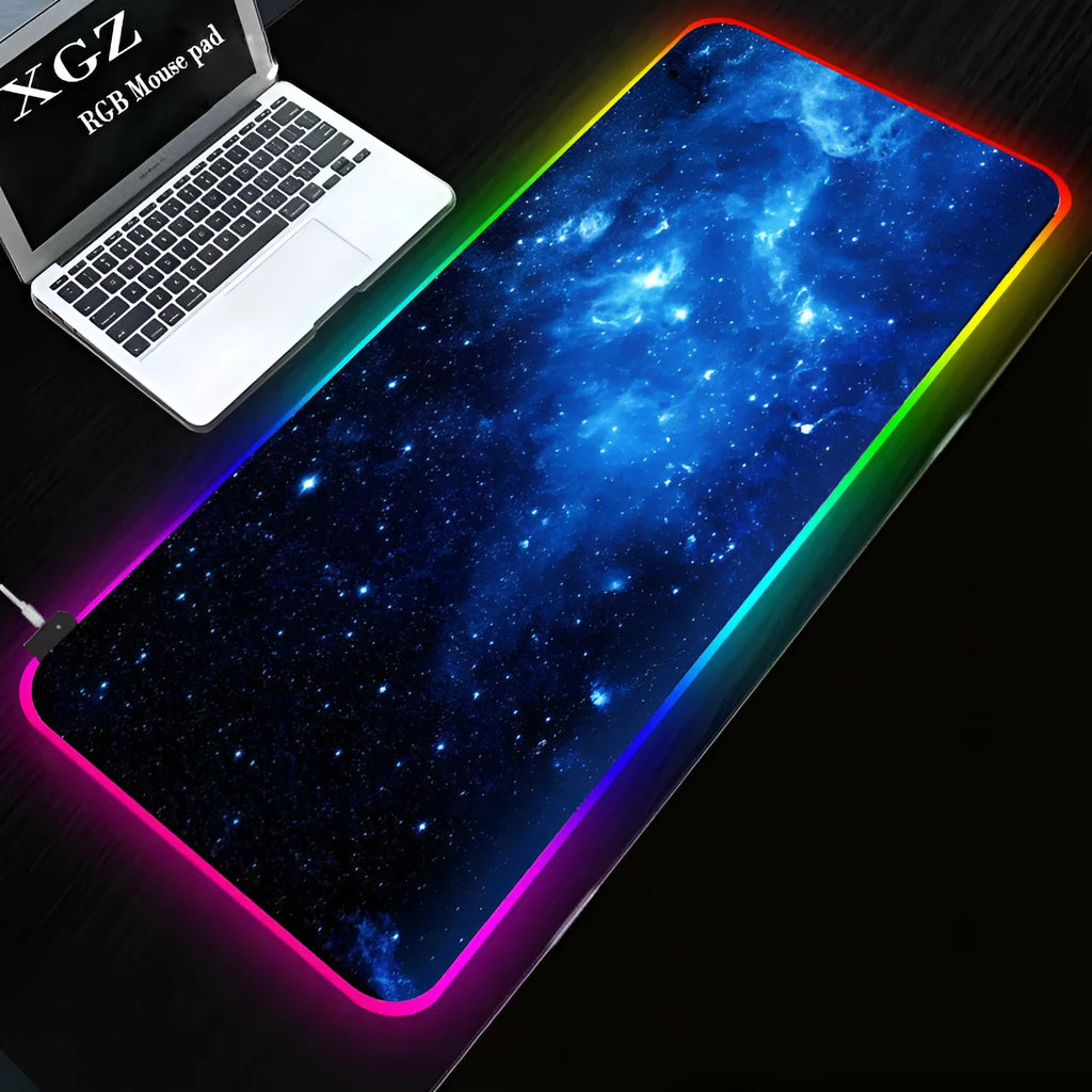 Symphony RGB luminous oversized mouse pad with USB cable on a desk, showing illuminated pattern and anti-slip rubber base.