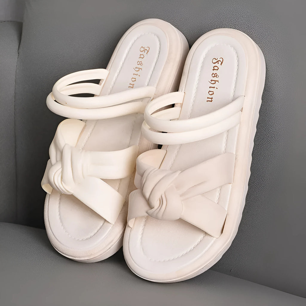Women's black and white PVC sandals with a soft back, two-way strap design, and a non-slip sole.