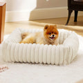 Soft winter dog bed cushion in beige colour showing raised sides and plush sleeping surface