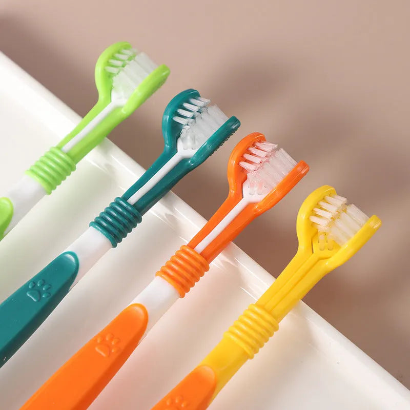 Plastic and nylon pet toothbrush in a sealed bag, colours include orange, green, and blue pink.