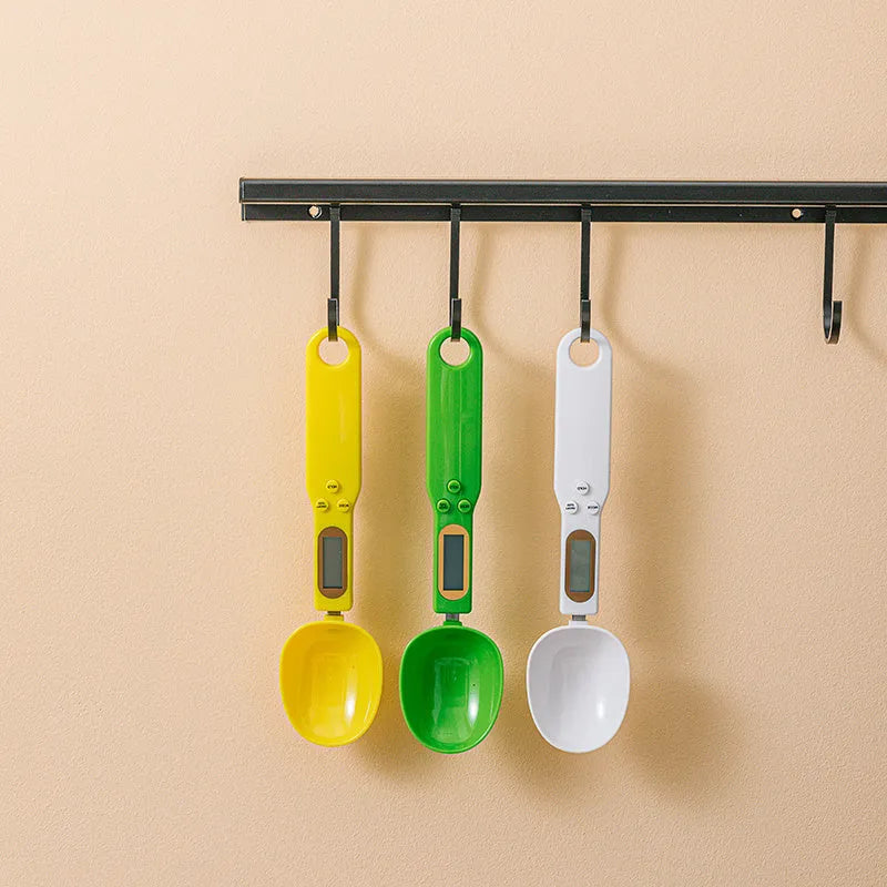 White digital spoon scale with LCD display showing weight measurement for kitchen ingredients