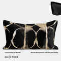 Black gold abstract pattern decorative cushion with removable cover in 45x45cm square size on a grey sofa.