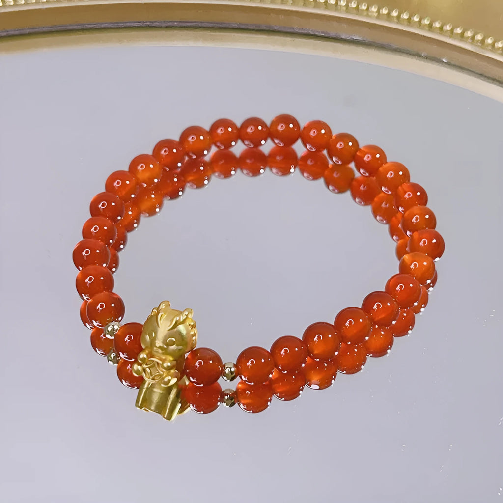 Close-up of a handmade red agate bracelet for women with a traditional Chinese dragon design.
