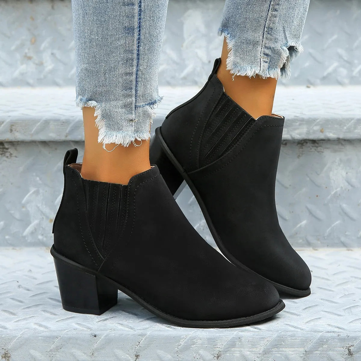 Women's black pointed toe ankle boots with thick square heel, slip-on design