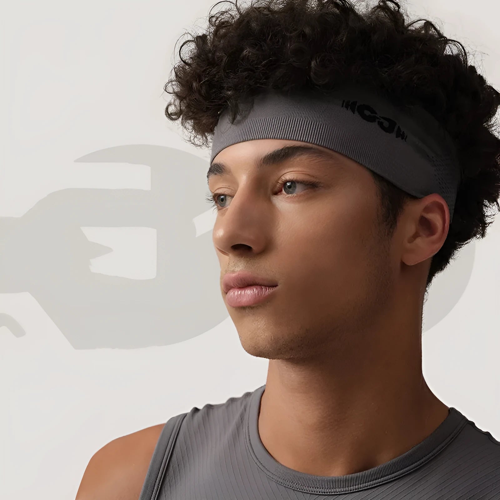 Seamless knitted exercise hair band in black colour shown on active person