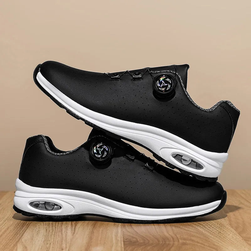 Low top black and white mesh casual shoes with cross shoulder straps and a composite sole.
