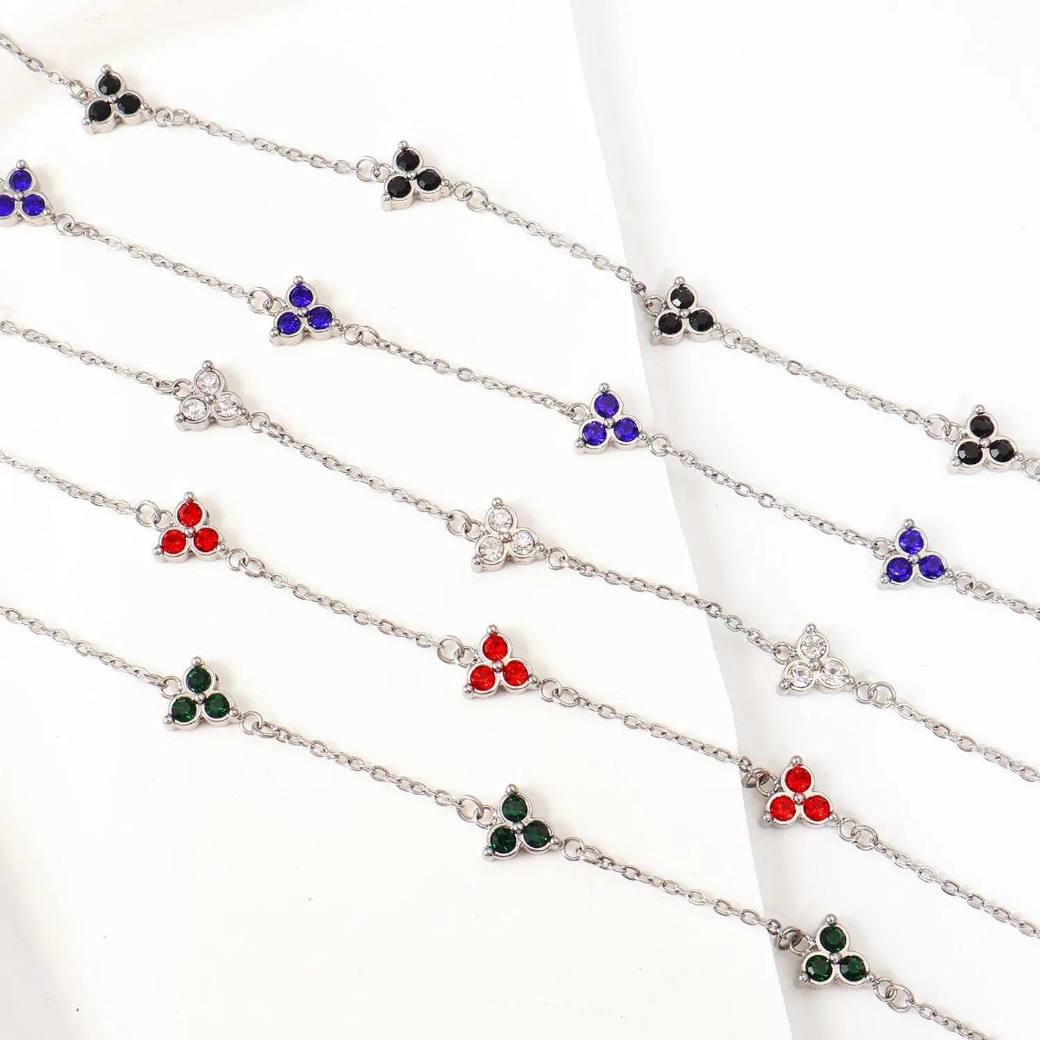 Women's stainless steel geometric bracelet with three diamond triangle design and coloured stone accents