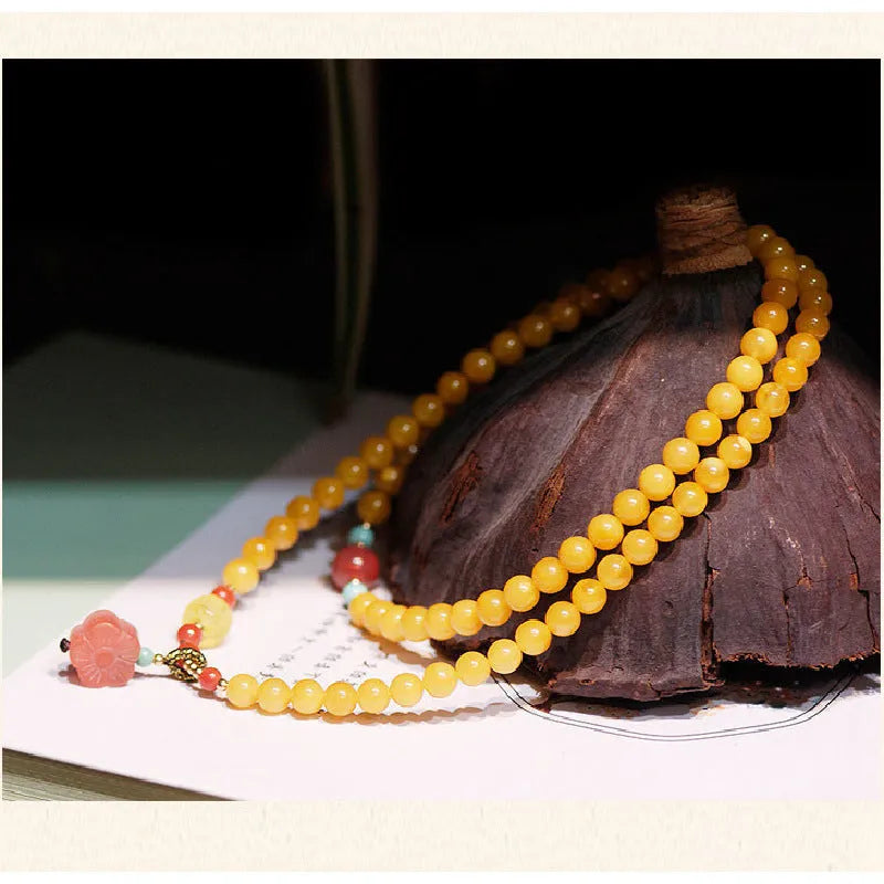 Women's retro-style amber bracelet with animal zodiac modelling in yellow chicken grease colour, 5mm round beads.