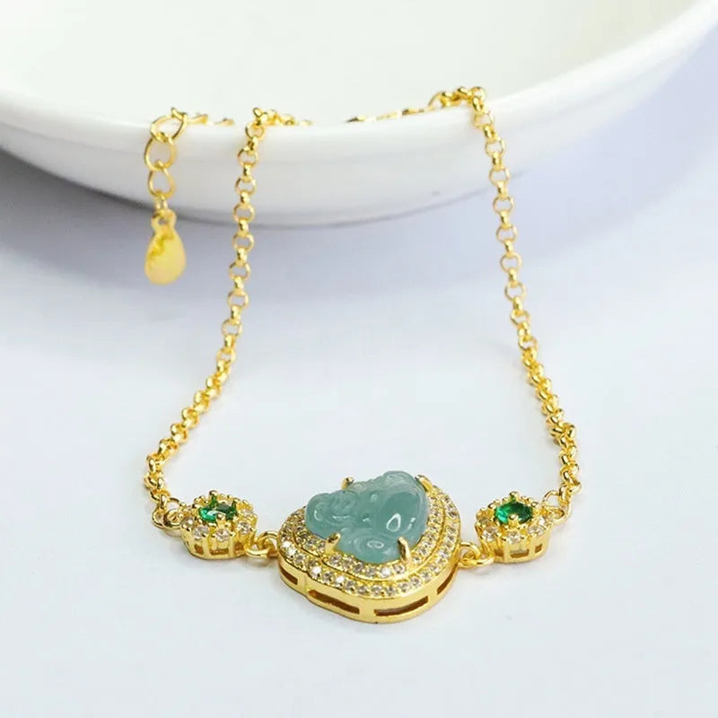 Women's jade bracelet with an inlaid blue Maitreya Buddha charm measuring 10mm by 13mm.