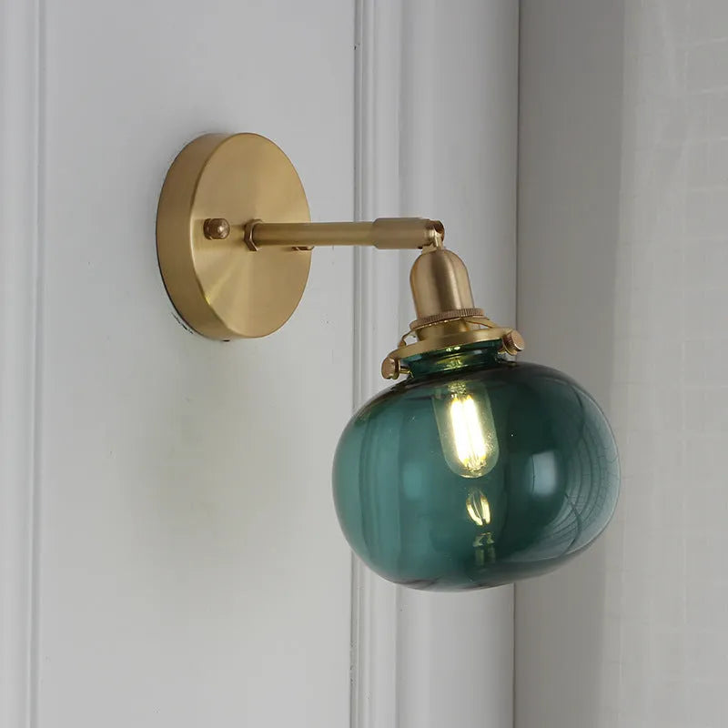 Glass wall lamp with a transparent or blue shade for living room or bedroom.