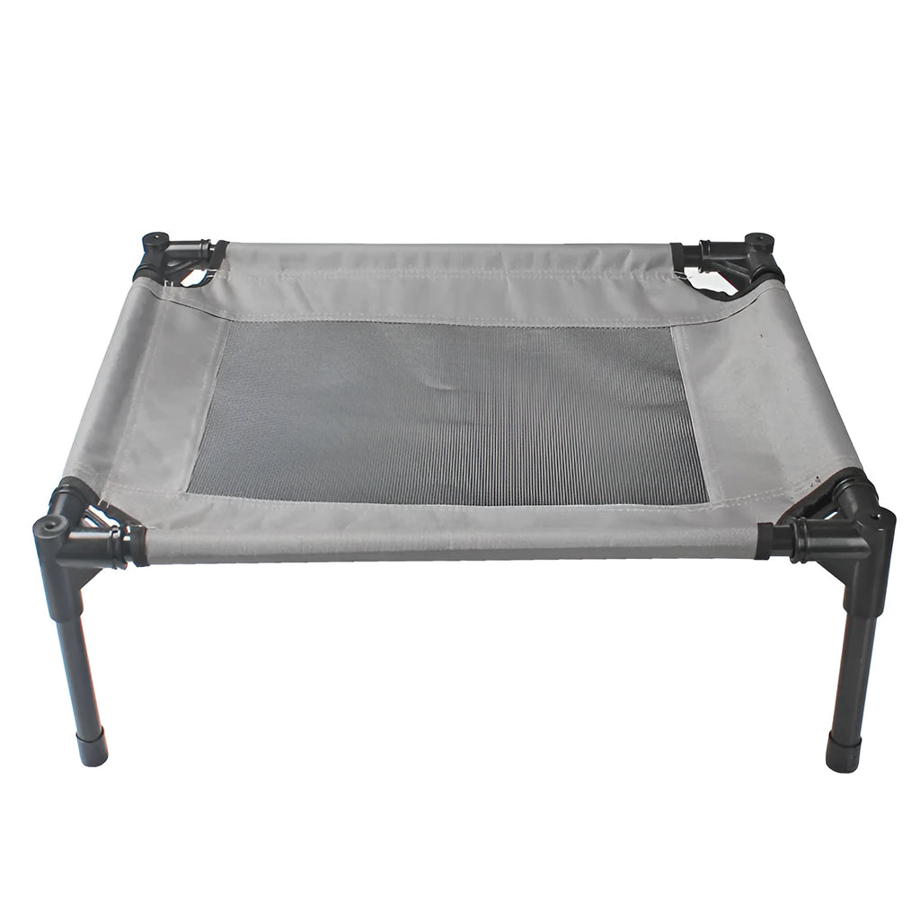 Black Oxford cloth outdoor dog bed with steel frame, shown on grass for camping use.