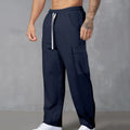 Men's navy blue corduroy cargo trousers with loose fit and straight legs on a hanger.