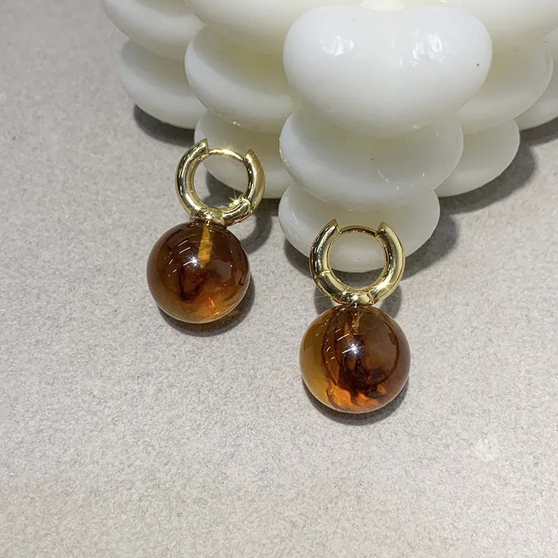 Simple Retro amber resin drop dangle earrings Style1, lightweight, approx 3.5 cm length, warm translucent colour, on neutral background