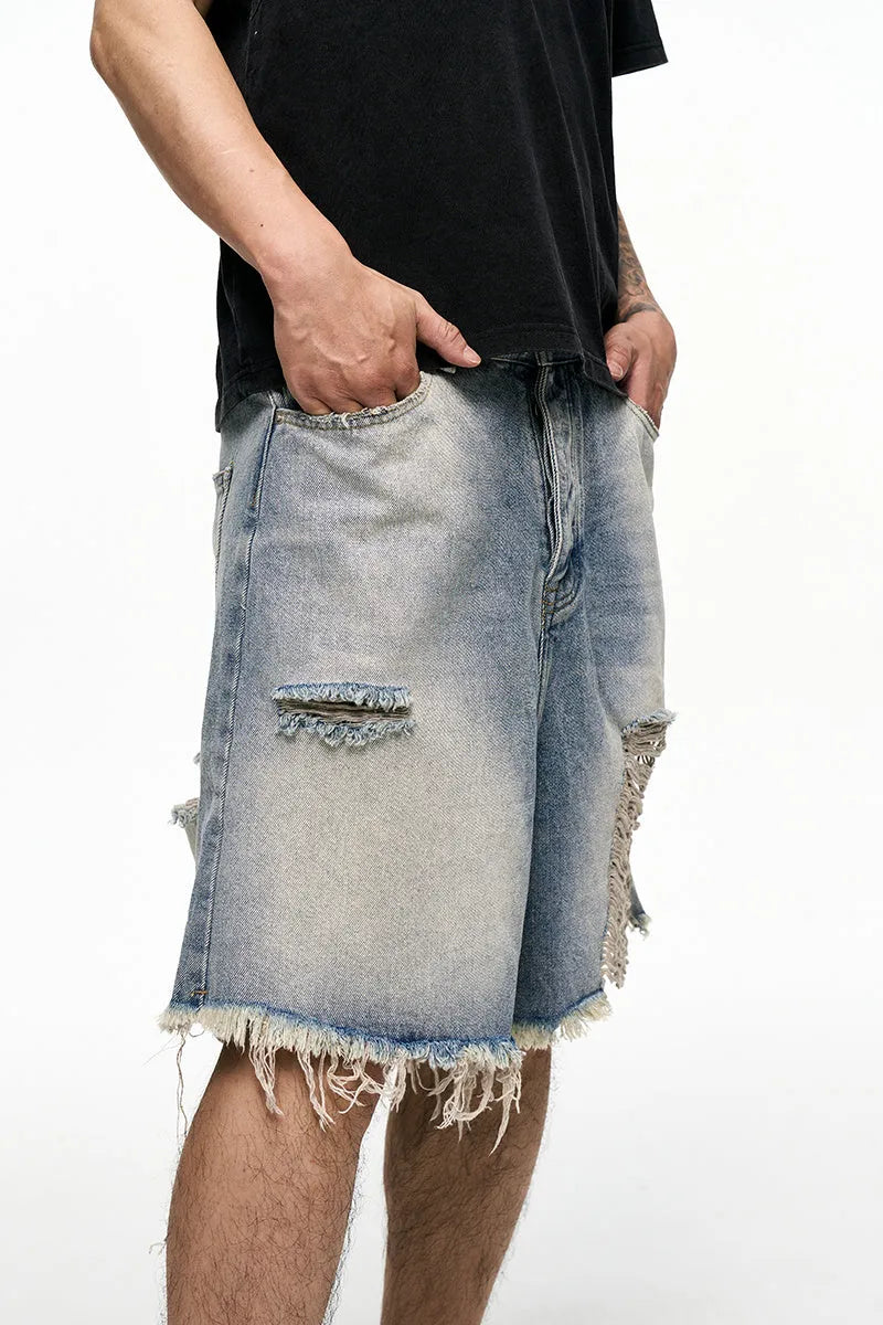 Men's light blue baggy denim shorts with wide leg cut and zip fly