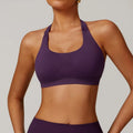 Women's black halter neck sports bra with removable pads on a mannequin.