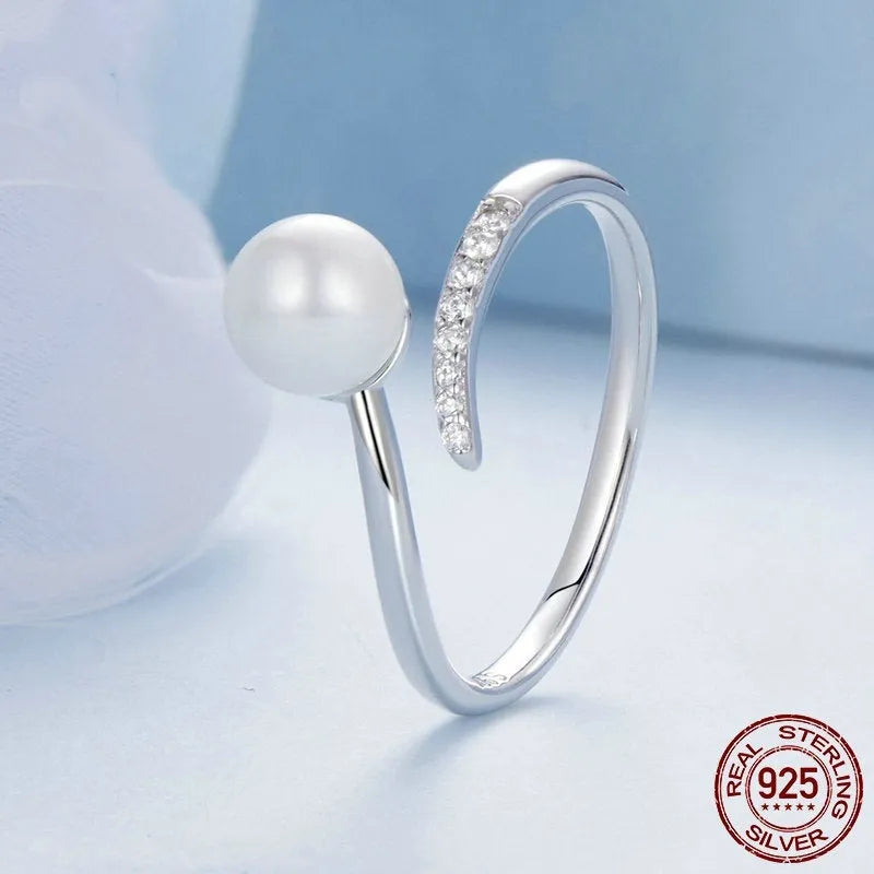 Adjustable S925 sterling silver ring with shell pearl centrepiece and open loop design