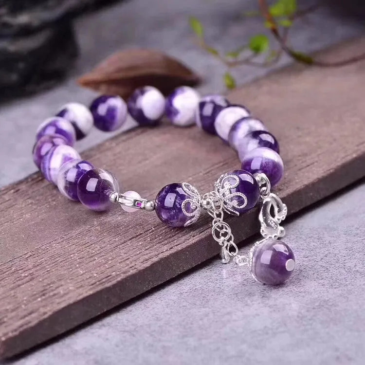 Amethyst bracelet for women with 10mm round beads on a wrist.