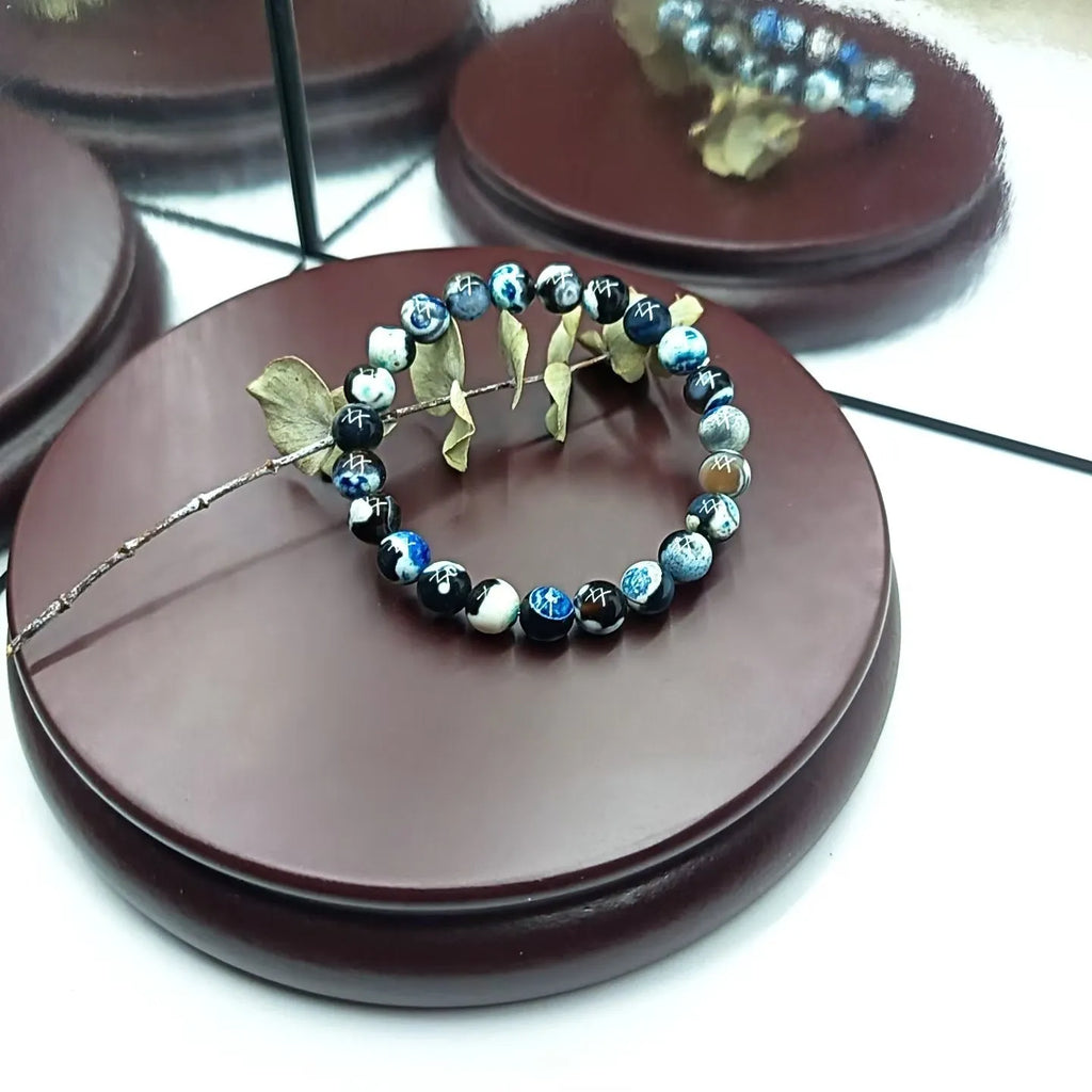 Close-up of a handmade Bohemian bracelet with round 8mm agate-style glass beads on a wrist.